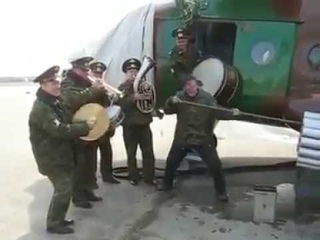 Russians cleaning their Mi-8 helicopter.